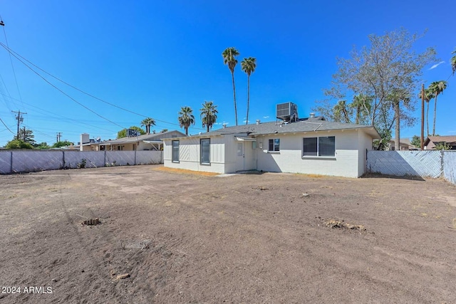 rear view of property with central AC unit