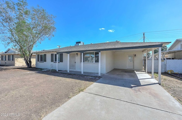 single story home with a carport and central air condition unit