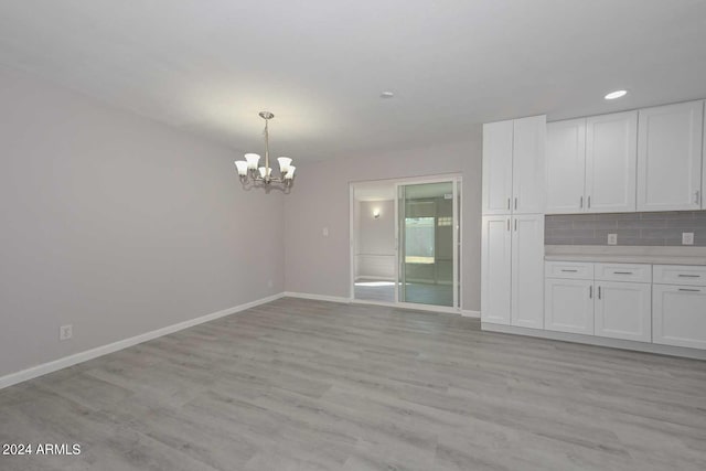 interior space featuring light hardwood / wood-style flooring and a notable chandelier