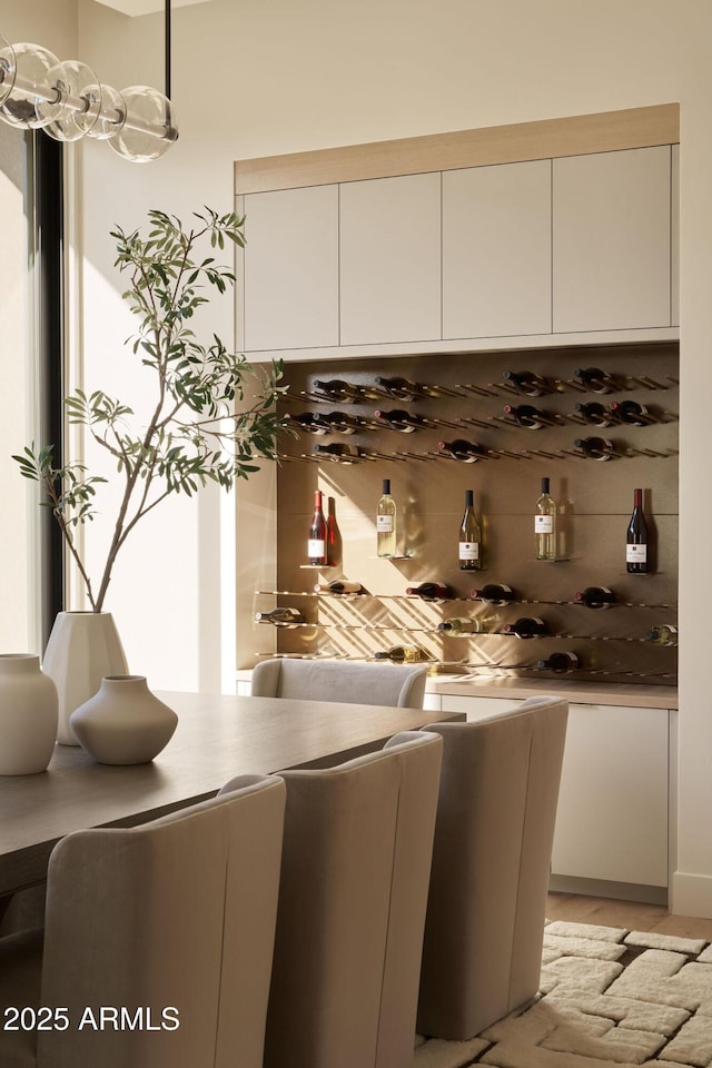 kitchen featuring decorative light fixtures, white cabinetry, and tasteful backsplash