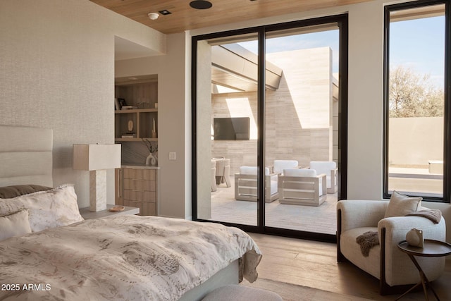 bedroom featuring access to exterior, multiple windows, and wood ceiling