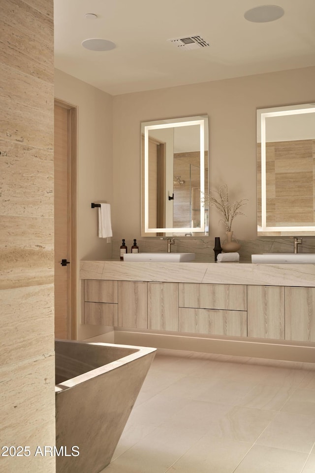 bathroom featuring tile patterned flooring and vanity