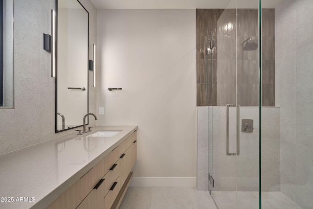 bathroom with vanity and a shower with shower door