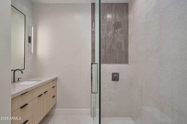 bathroom featuring vanity and a shower with shower door