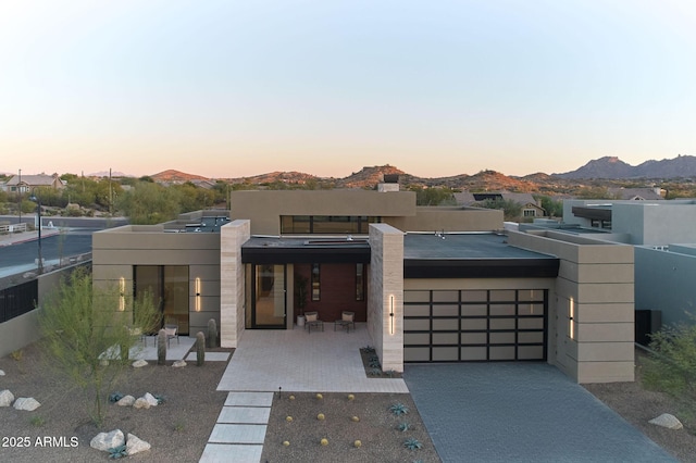 contemporary house with a garage and a mountain view