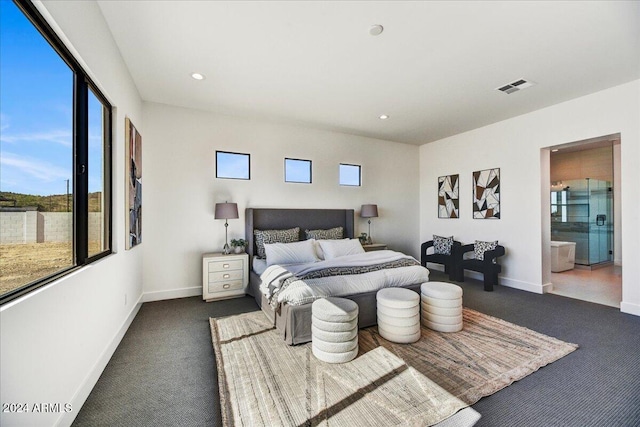 carpeted bedroom featuring connected bathroom