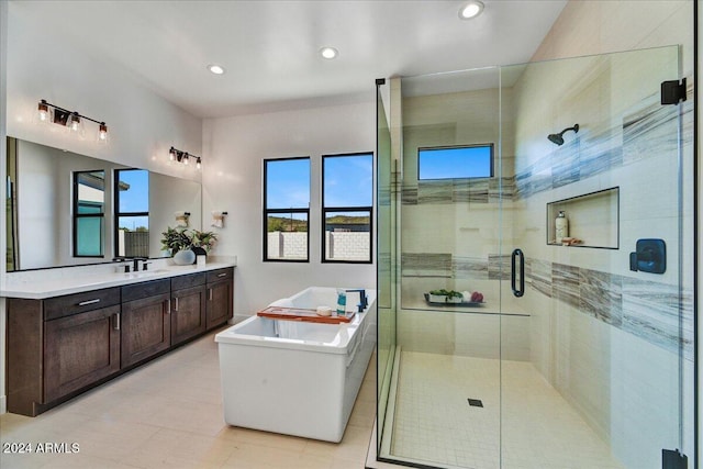 bathroom with vanity, independent shower and bath, and a healthy amount of sunlight