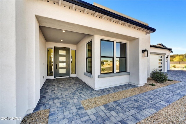 view of exterior entry with a garage