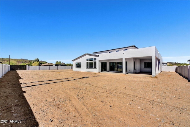 back of house with a patio area