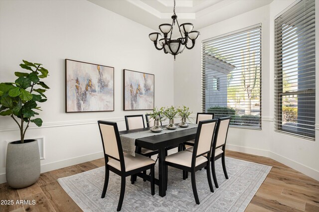 3946 N Pinnacle Hills Cir, Mesa, AZ 85207 - dining room featuring a chandelier, wood finished floors, and a raised ceiling