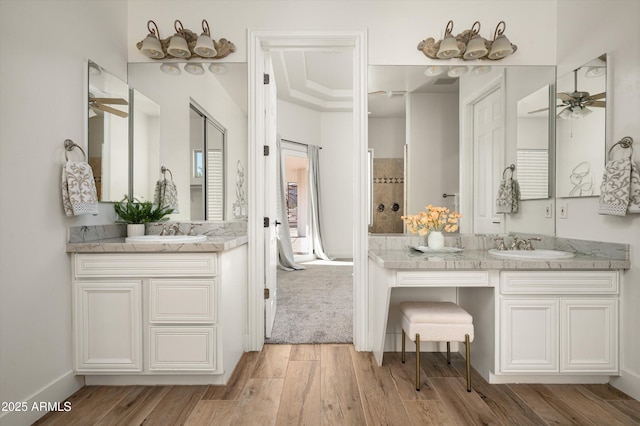3946 N Pinnacle Hills Cir, Mesa, AZ 85207 - bathroom featuring ceiling fan, two vanities, and wood finished floors