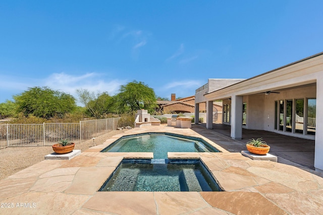 3946 N Pinnacle Hills Cir, Mesa, AZ 85207 - view of pool featuring an outdoor kitchen, a fenced backyard, a patio, a ceiling fan, and a pool with connected hot tub