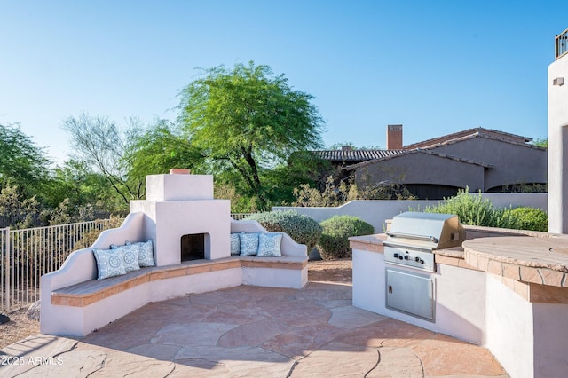 3946 N Pinnacle Hills Cir, Mesa, AZ 85207 - view of patio / terrace with an outdoor fireplace and exterior kitchen