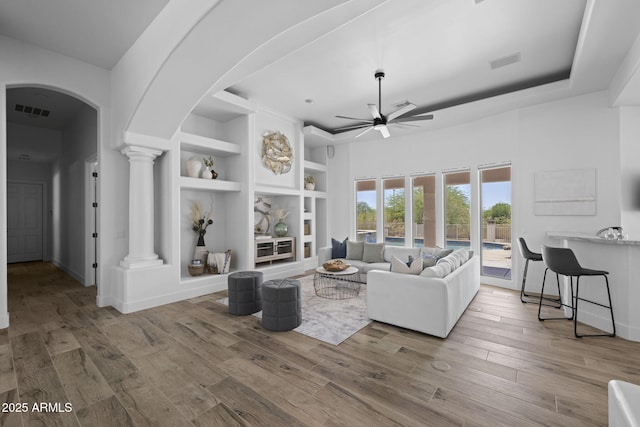 3946 N Pinnacle Hills Cir, Mesa, AZ 85207 - living area with a ceiling fan, arched walkways, decorative columns, built in features, and wood finished floors