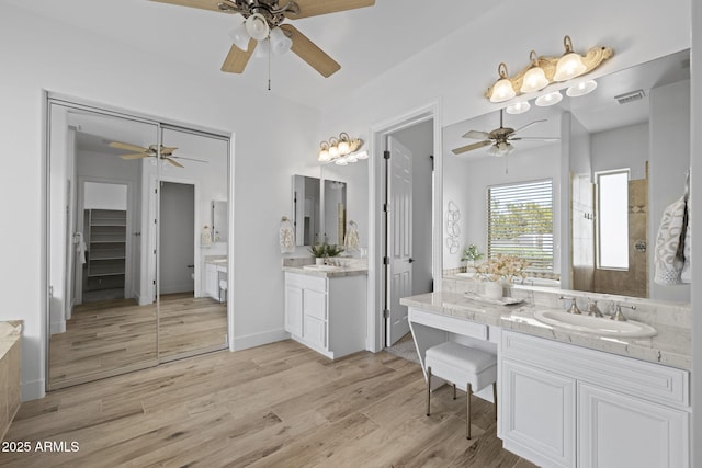 3946 N Pinnacle Hills Cir, Mesa, AZ 85207 - full bath featuring a ceiling fan, wood finished floors, two vanities, and a closet