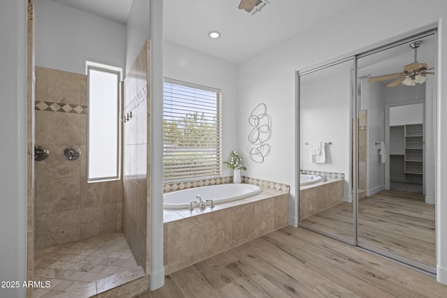 3946 N Pinnacle Hills Cir, Mesa, AZ 85207 - full bath featuring a tile shower, a bath, wood finished floors, a ceiling fan, and a spacious closet