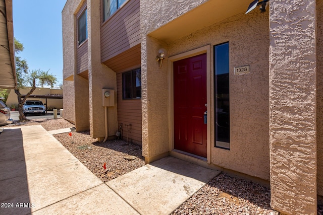 property entrance featuring stucco siding