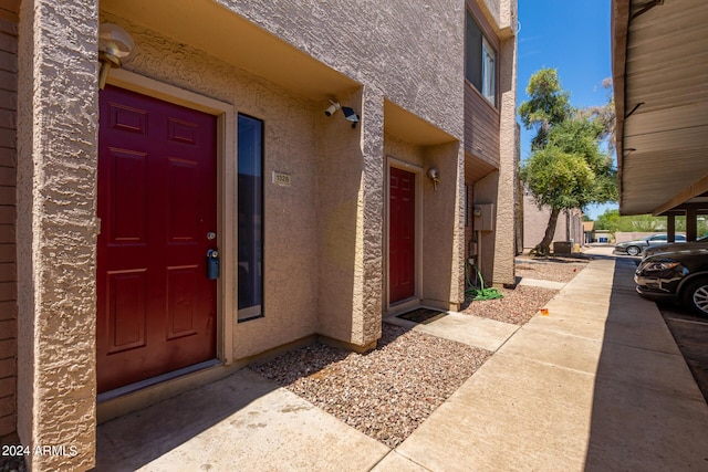 property entrance with stucco siding