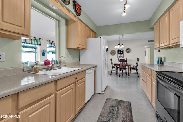 kitchen with light brown cabinets, white appliances, and sink