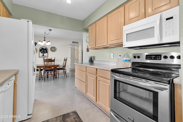 kitchen featuring light brown cabinetry, pendant lighting, white appliances, and a notable chandelier