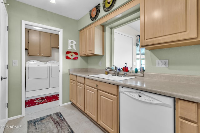 kitchen featuring dishwasher, sink, separate washer and dryer, light brown cabinetry, and light tile patterned flooring