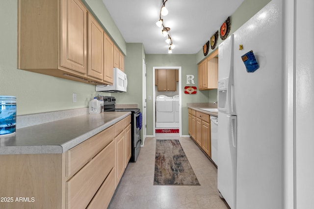 kitchen with sink, washer and clothes dryer, white appliances, and light brown cabinets