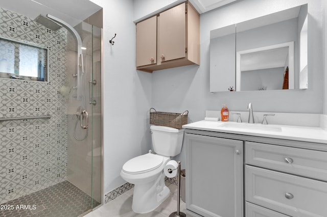 bathroom with tile patterned floors, vanity, a shower with shower door, and toilet