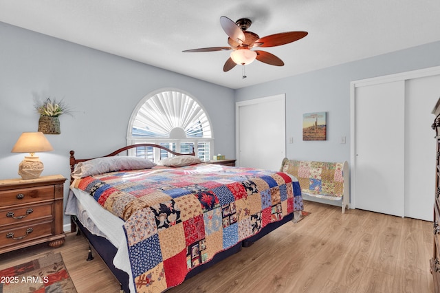 bedroom with light hardwood / wood-style floors and ceiling fan