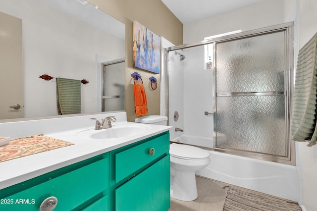 full bathroom featuring shower / bath combination with glass door, tile patterned flooring, vanity, and toilet