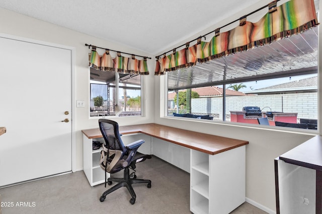 office area with a textured ceiling