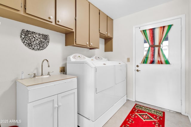 laundry room featuring cabinets, sink, and washer and dryer