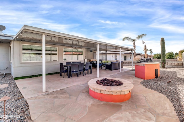 view of patio with a fire pit and exterior kitchen