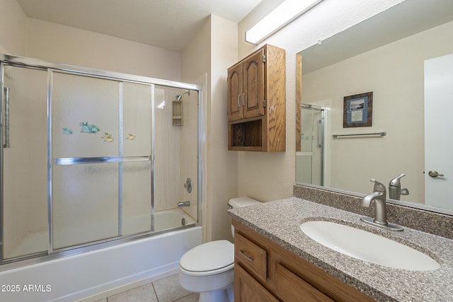 full bath featuring toilet, shower / bath combination with glass door, tile patterned flooring, and vanity