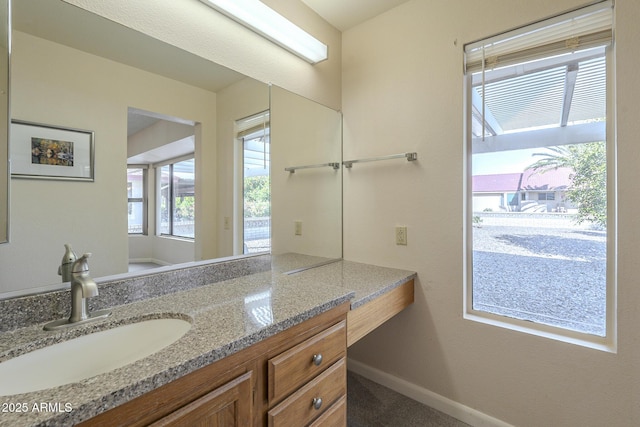 bathroom featuring baseboards and vanity