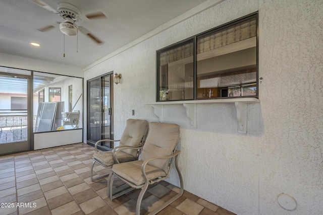 sunroom featuring ceiling fan