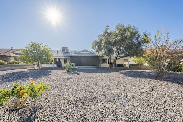 view of front of home with a sunroom and central air condition unit