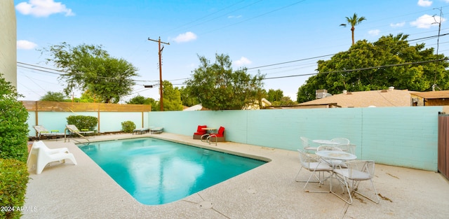 view of swimming pool featuring a patio area