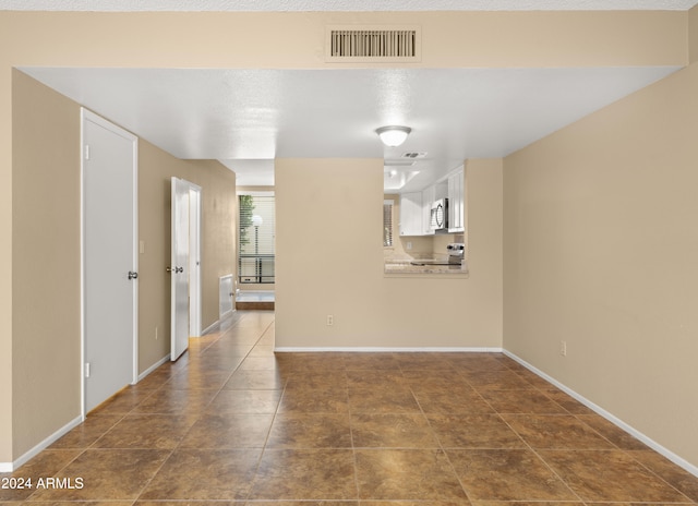 unfurnished living room with tile patterned floors