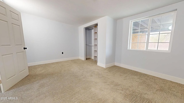 unfurnished bedroom featuring light colored carpet