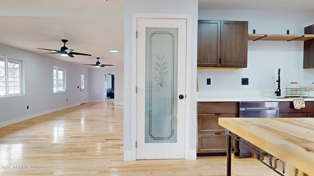 kitchen with dark brown cabinetry and light hardwood / wood-style floors