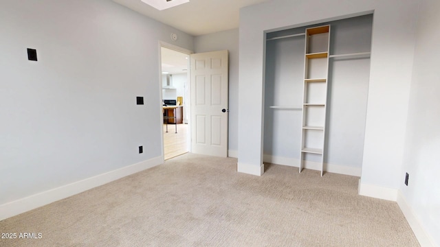 unfurnished bedroom featuring light colored carpet and a closet