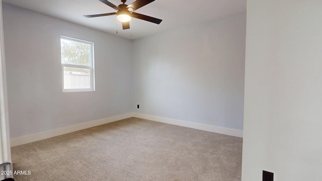 spare room featuring light colored carpet and ceiling fan