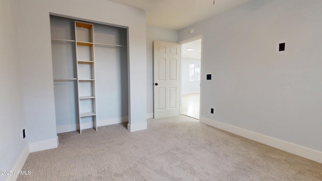 unfurnished bedroom with carpet floors and a closet