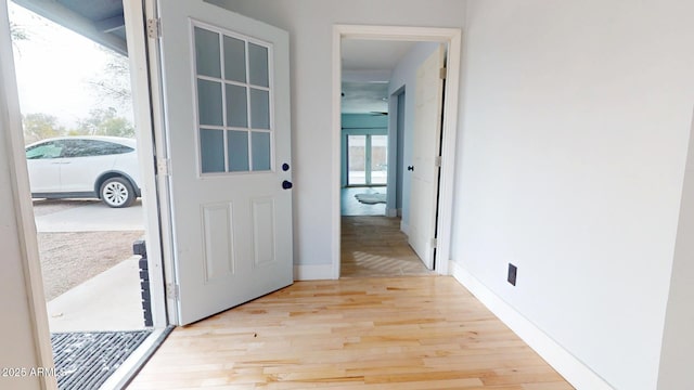 doorway to outside with light wood-type flooring