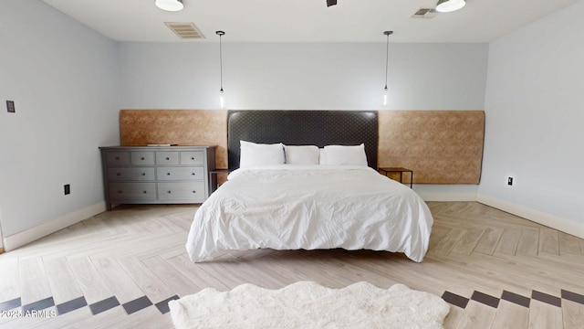 bedroom with light parquet flooring