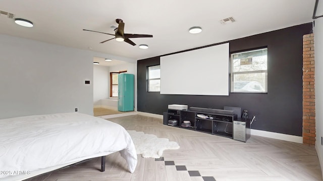 bedroom with ceiling fan and light parquet floors