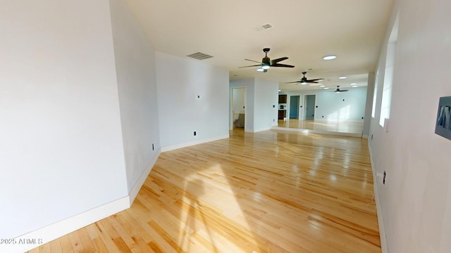 empty room with hardwood / wood-style floors and ceiling fan