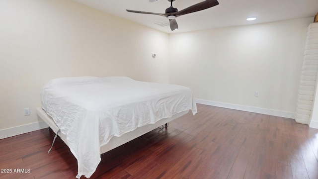 bedroom with ceiling fan and dark hardwood / wood-style floors