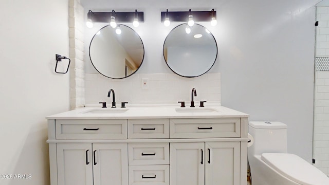 bathroom with vanity, decorative backsplash, and toilet