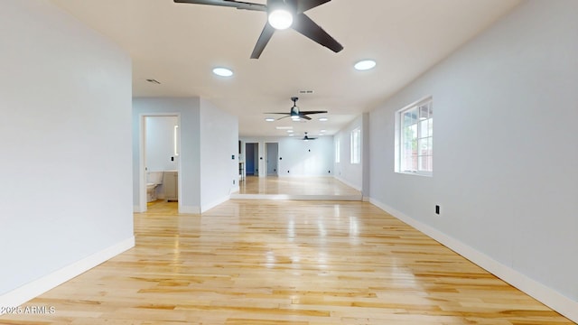 unfurnished living room featuring ceiling fan and light hardwood / wood-style floors